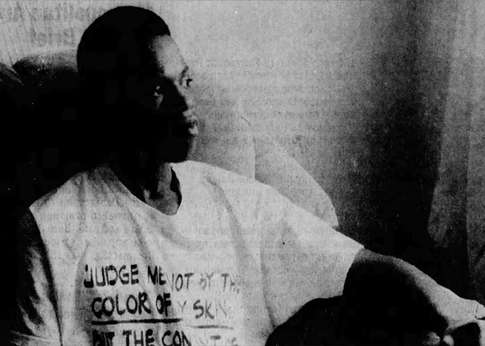 An old, grainy photo of a person wearing a T-shirt, related to the track star's story and Olympic dreams. An old, grainy photo of a person wearing a T-shirt, related to the track star's story and Olympic dreams.