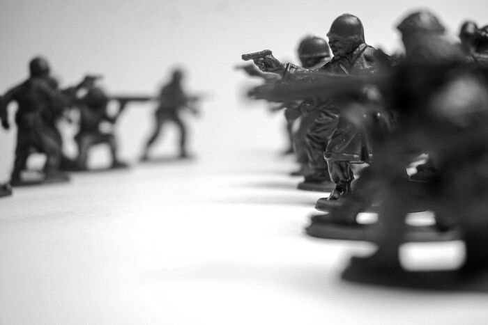 Toy soldiers in black and white, facing each other in rows, illustrating the challenging questions kids ask.
