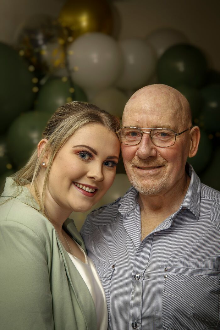 A young woman and an older man smiling together at a celebration, an example of an age-gap relationship.