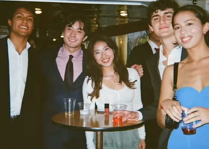 Young adults at a party, possibly using a new dystopian dating method taking over California colleges. Young adults at a party, possibly using a new dystopian dating method taking over California colleges.