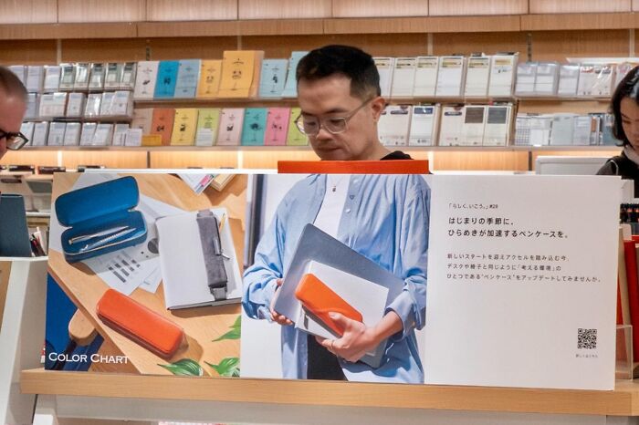Street coincidence: A man in a store seems to hold items from a display poster, as seen by Edas Wong.