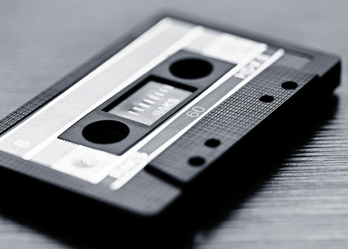 A vintage cassette tape, evoking a feeling of reality breaking for a moment.