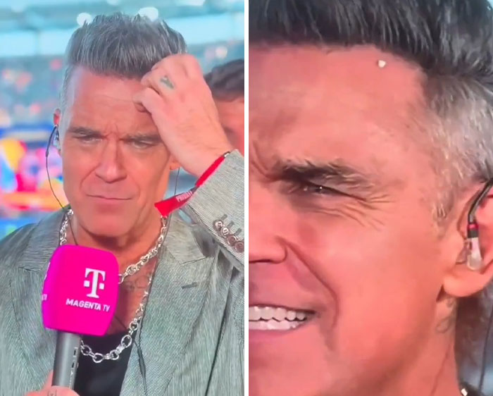 Close-up of Robbie Williams looking concerned after a white substance fell on his mic during the World Cup. Close-up of Robbie Williams looking concerned after a white substance fell on his mic during the World Cup.