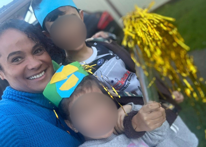 Mom smiling with her two kids in party hats, before the tragic marshmallow accident that claimed her life.