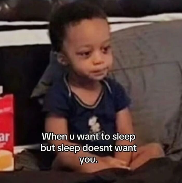 Relatable meme of a young child looking tired, expressing the struggle of wanting to sleep but sleep not wanting you.