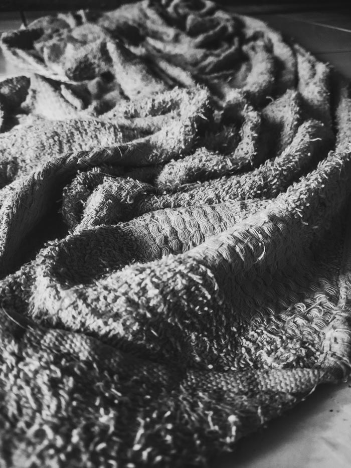 A crumpled, dirty towel, symbolizing unhygienic conditions.