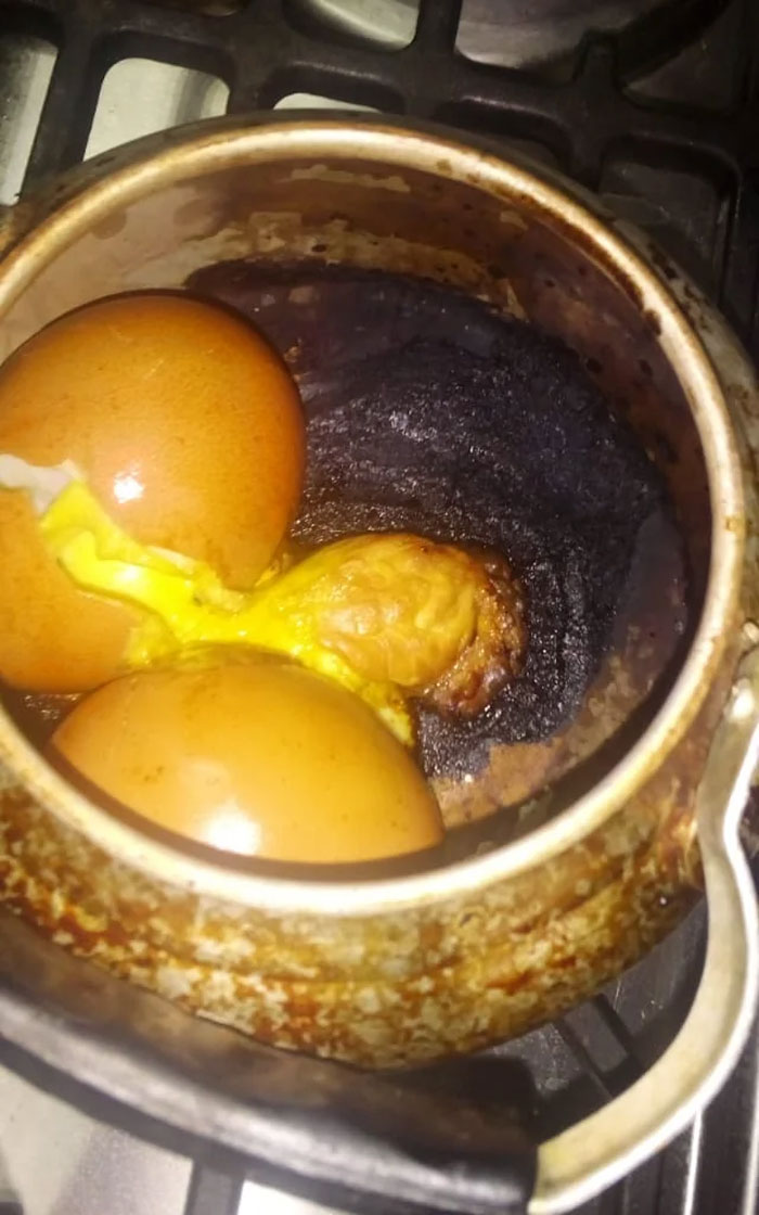 Burnt eggs in a pot on a stove, a clear example of how forgetting something can ruin a day.