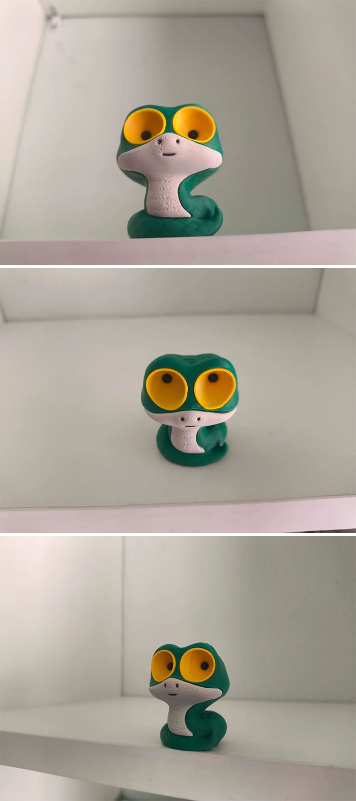 A green 3D printed snake figurine with big yellow eyes, highlighting cool and useful things people printed with their 3D printers.