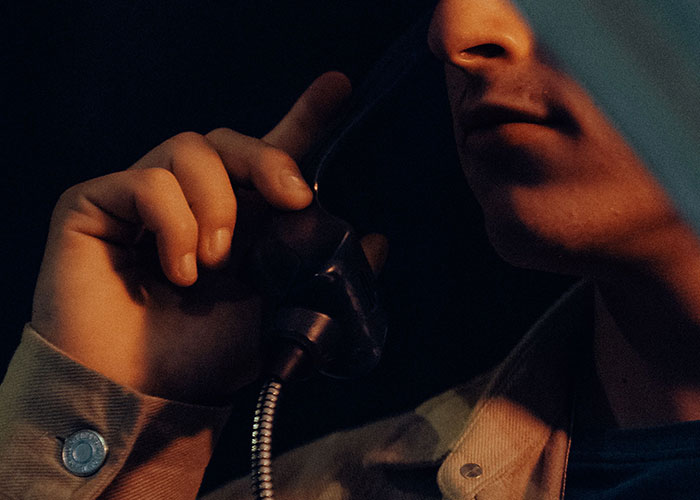 A man holds a phone receiver to his ear. Many people swear they witnessed reality break for a second.