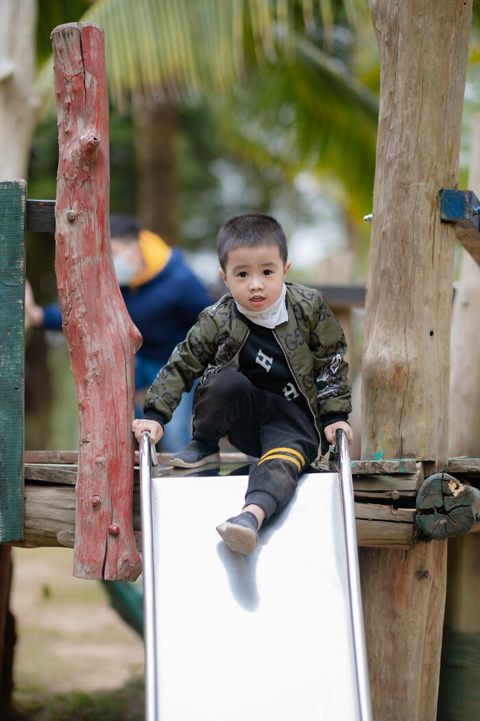 Parenting expert showing a child on a playground slide, revealing kids understanding and confusion.