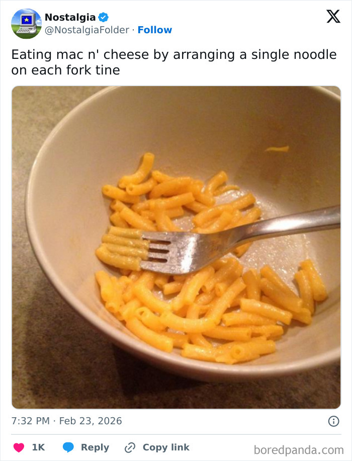 A bowl of macaroni and cheese with a fork, recalling a nostalgic way of eating.