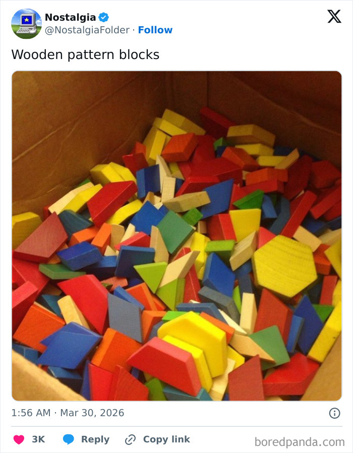 A box filled with colorful wooden pattern blocks, a classic toy from childhood, bringing back nostalgic memories.