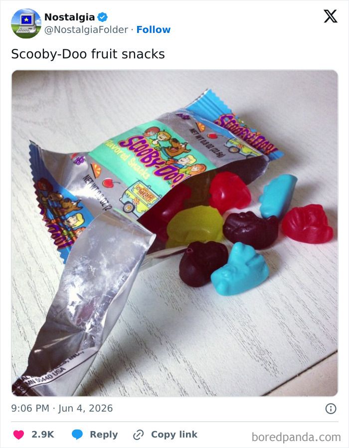 An opened package of Scooby-Doo fruit snacks, with several colorful gummy snacks spilled out, a nostalgic folder item.