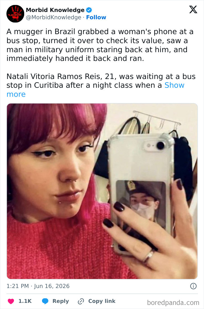 A woman with pink hair takes a selfie, reflecting a picture of a man in military uniform. Sad stories of worst days.