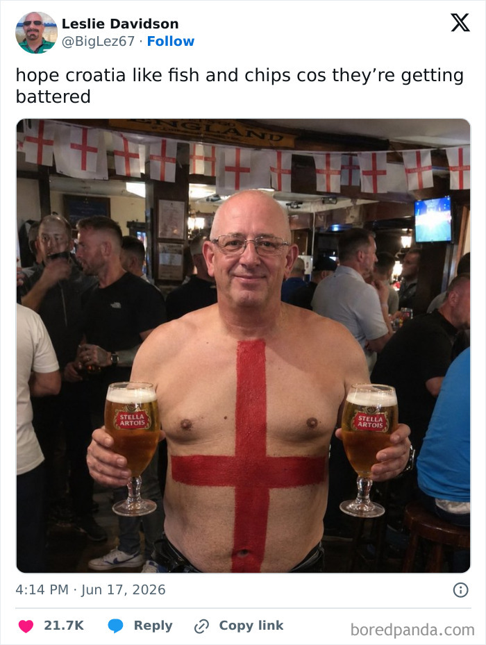 A football fan with England flag painted on his chest, holding two beers, part of funniest World Cup tweets.