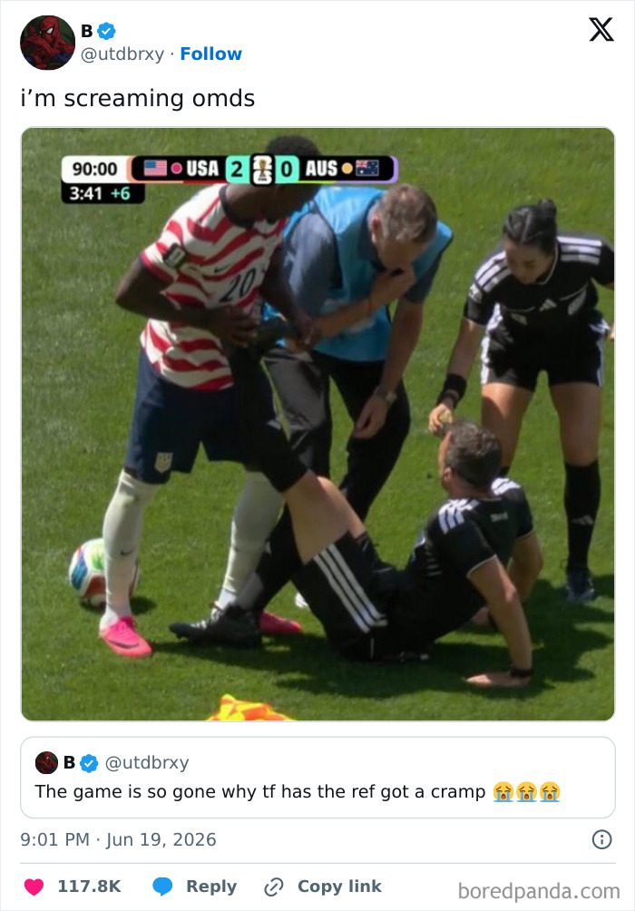 A football referee on the ground with a cramp during a game, from funniest World Cup tweets.