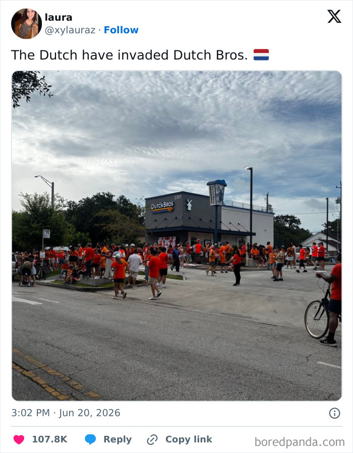 A large crowd of people in orange shirts gathered outside a Dutch Bros, humorously invading the coffee shop.