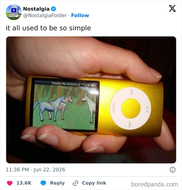 A hand holding a golden iPod Nano displaying Charlie the Unicorn, a blast from the past for nostalgia.