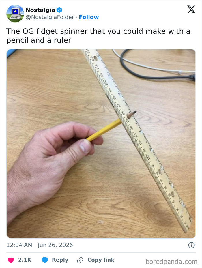 A hand holding a pencil and ruler, creating a simple fidget spinner, a nostalgic memory for many.