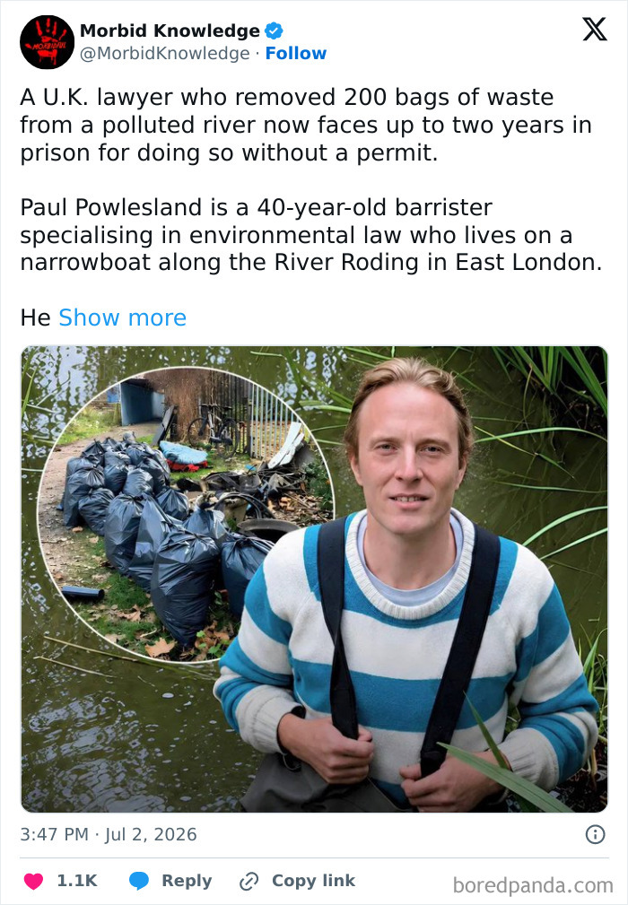A man standing in water with bags of waste, representing morbid and sad stories.