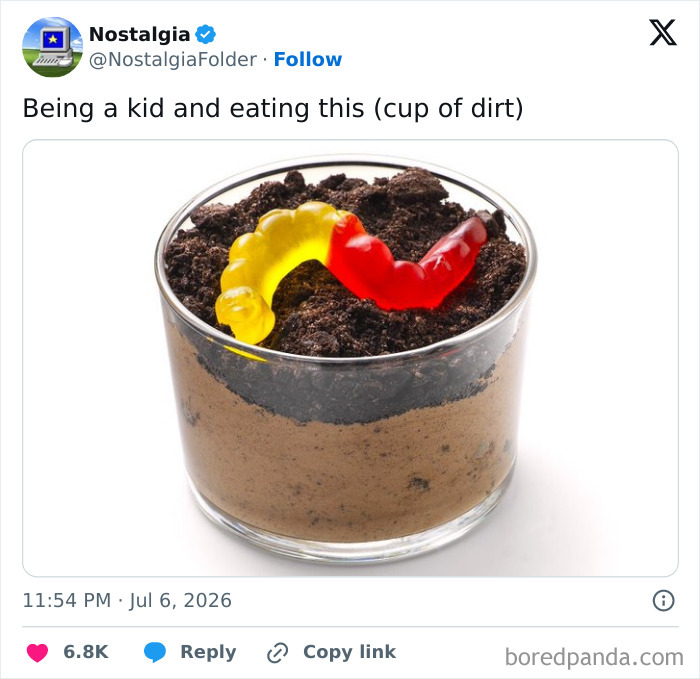 A cup of dirt dessert with gummy worms, a nostalgic treat from childhood.