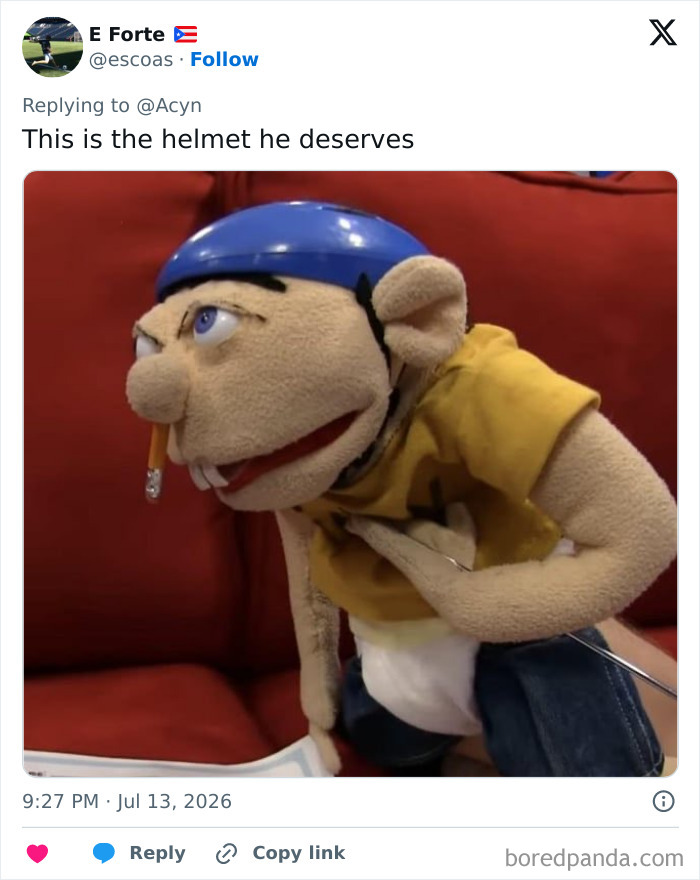 A puppet wearing a blue helmet, meant to mock Trump and his special helmet gift.
