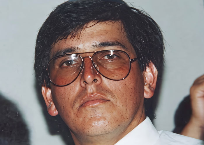A man with glasses looks intently, possibly involved in the case of the disappeared man's horrific fate.