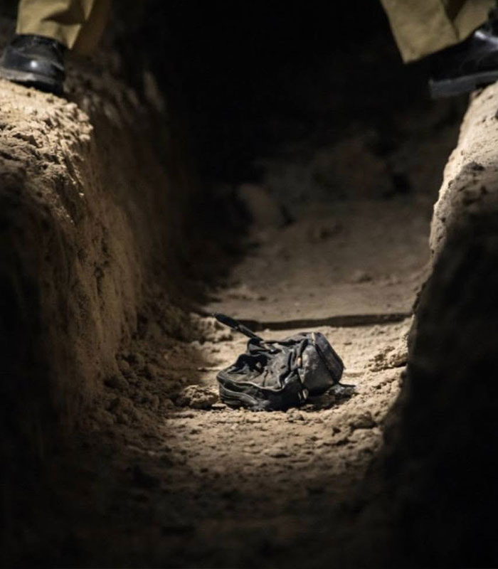 A black bag lies in a dug-out trench, hinting at the horrific fate of a disappeared man.