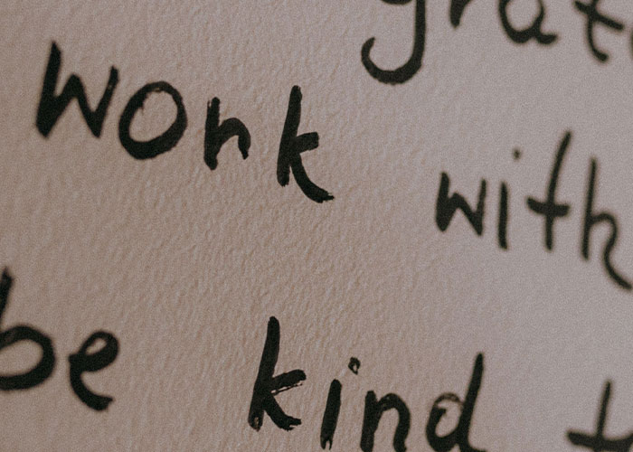 Close-up of handwritten words on paper, emphasizing the need to leave a man's home immediately when uncomfortable.