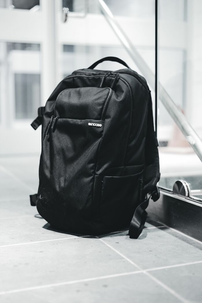 A black backpack on the floor, suggesting someone might have gotten fired from their job and left hastily.