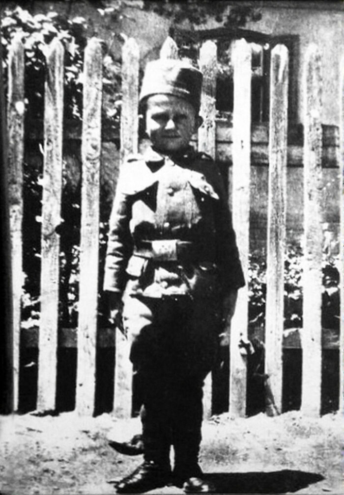 Black and white photo of a young boy in military uniform, an interesting fact about history.