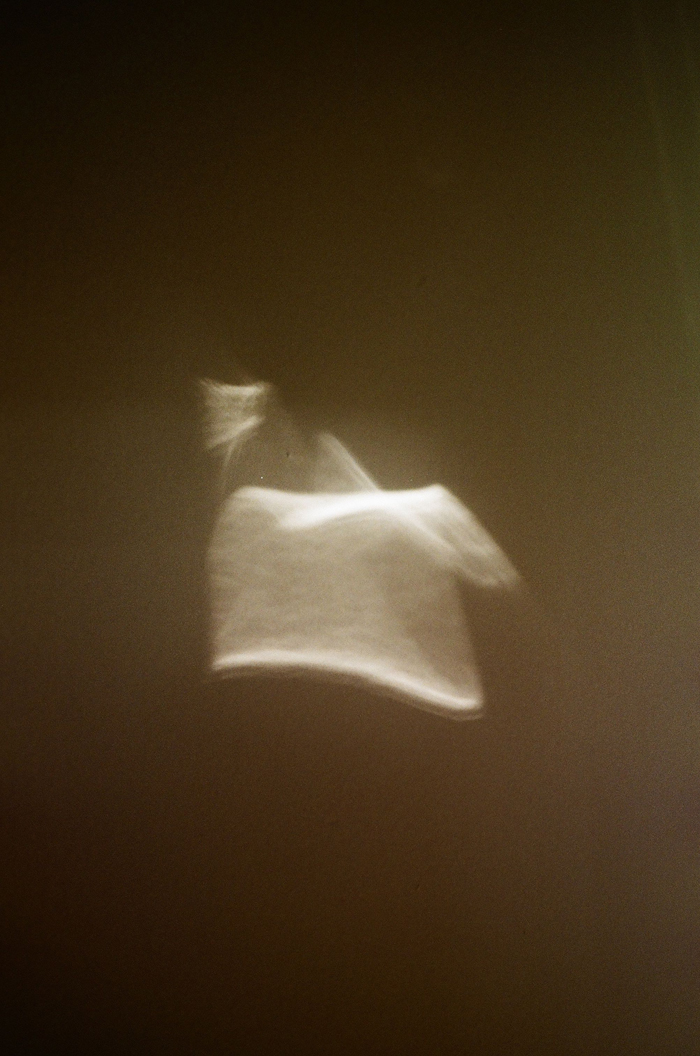 An abstract, glowing white light against a dark background, representing mysterious things and creepy stories.