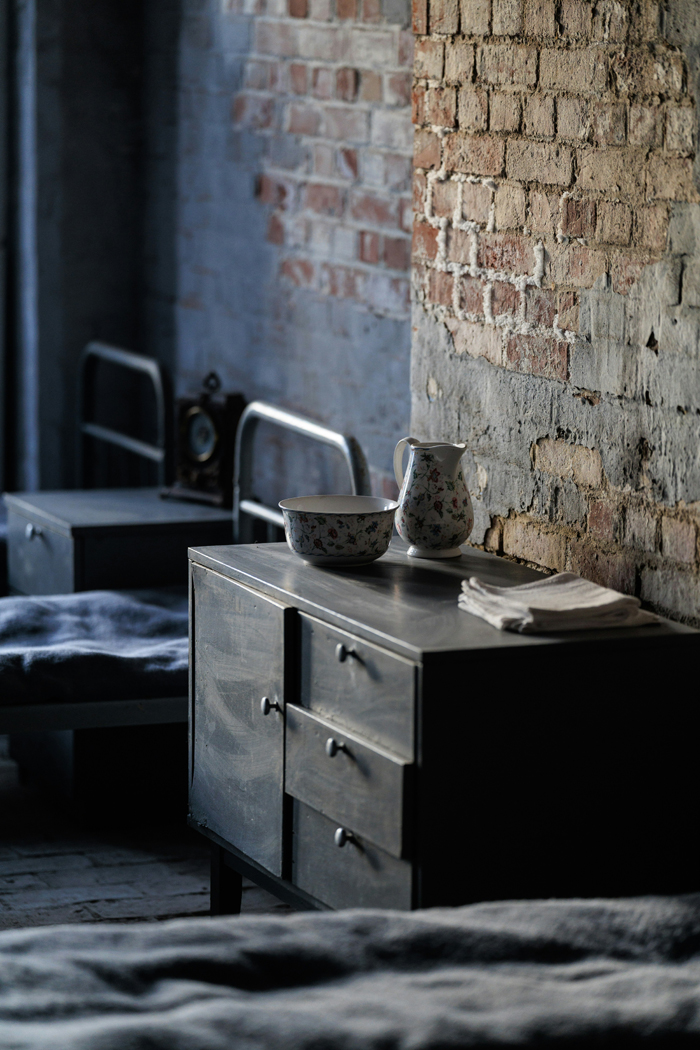 A dark, rustic room with a dresser and bed, illustrating mysterious things and creepy stories.