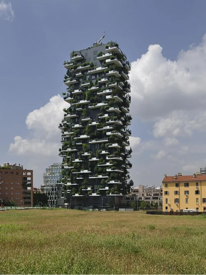 A tall, green high-rise building with lush trees on every balcony, an amazing modern architecture design.
