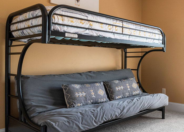 A bunk bed with a futon underneath, indicating a man's home women had to leave immediately.