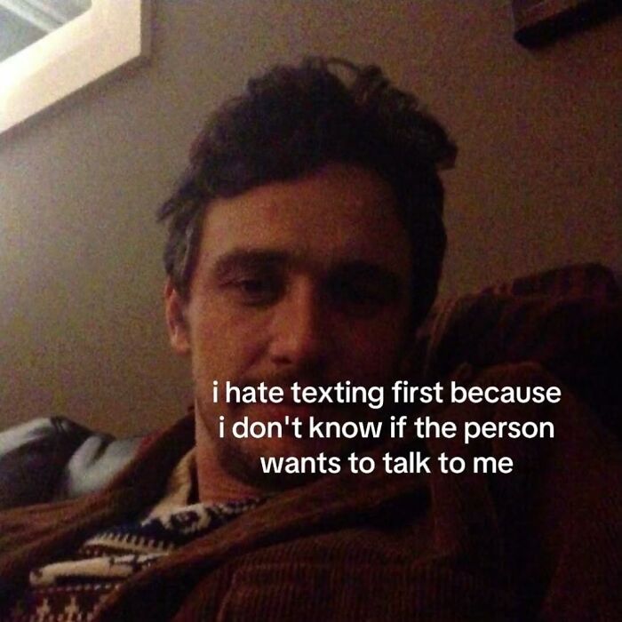 A man with messy hair looking at the camera, a relatable meme about not wanting to text first.