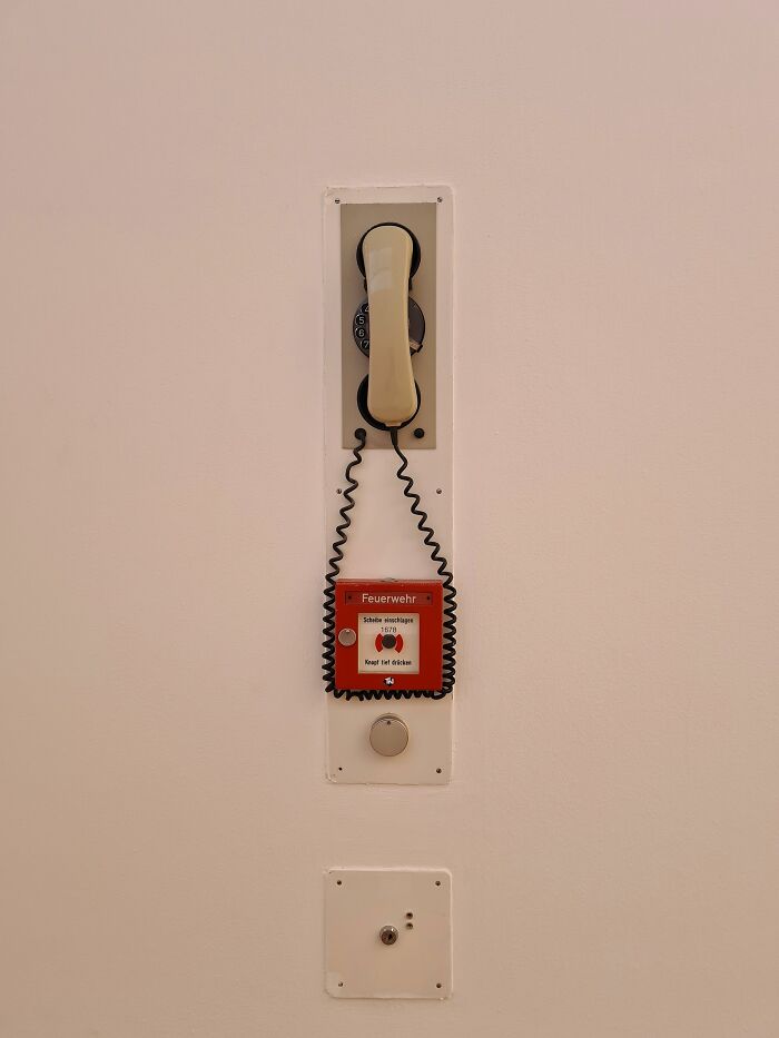 An old telephone and a fire alarm, indicating an emergency or a situation that led to someone getting fired from their job.