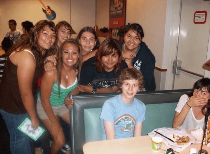 Michael Cera poses with fans at a restaurant, showing an instance people asked celebrities for a photo.