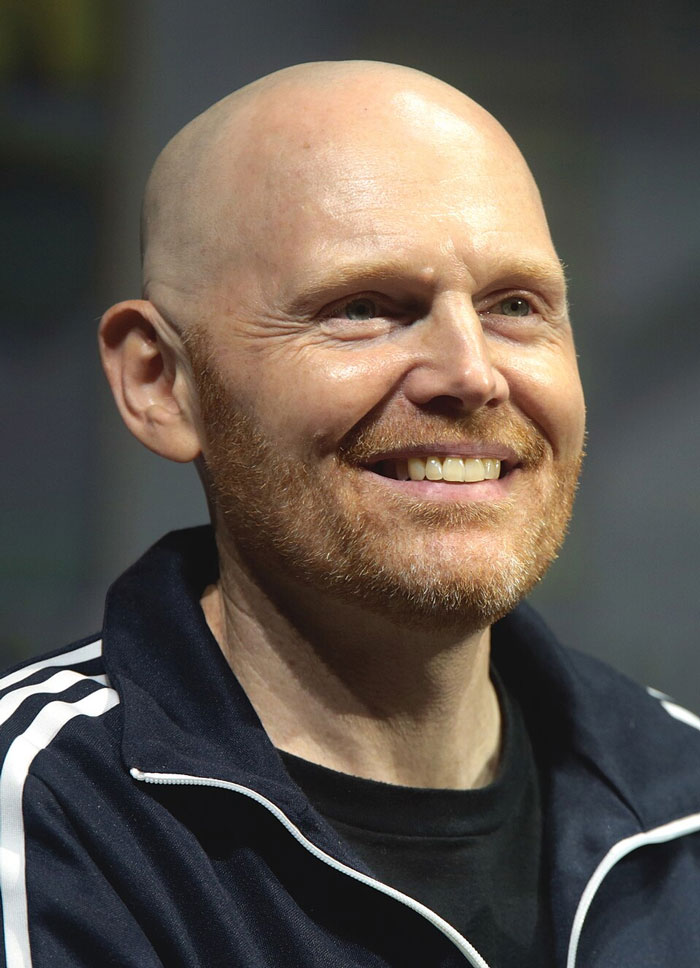 A smiling bald man with a beard, wearing an Adidas jacket, showing one of the most clever comebacks.