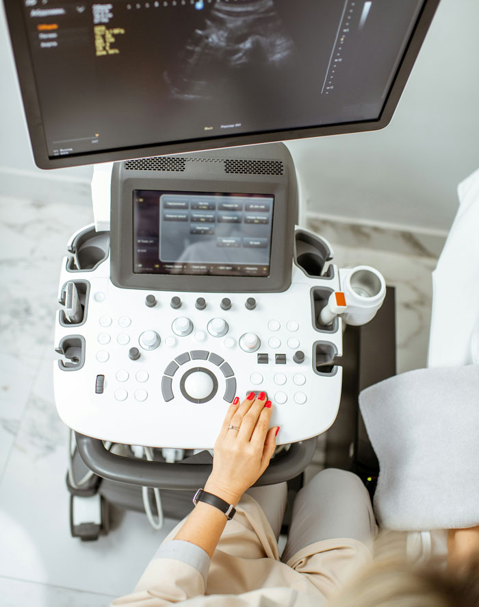 An ultrasound machine showing a baby scan, illustrating the medical aspect of having a baby before men walked out.
