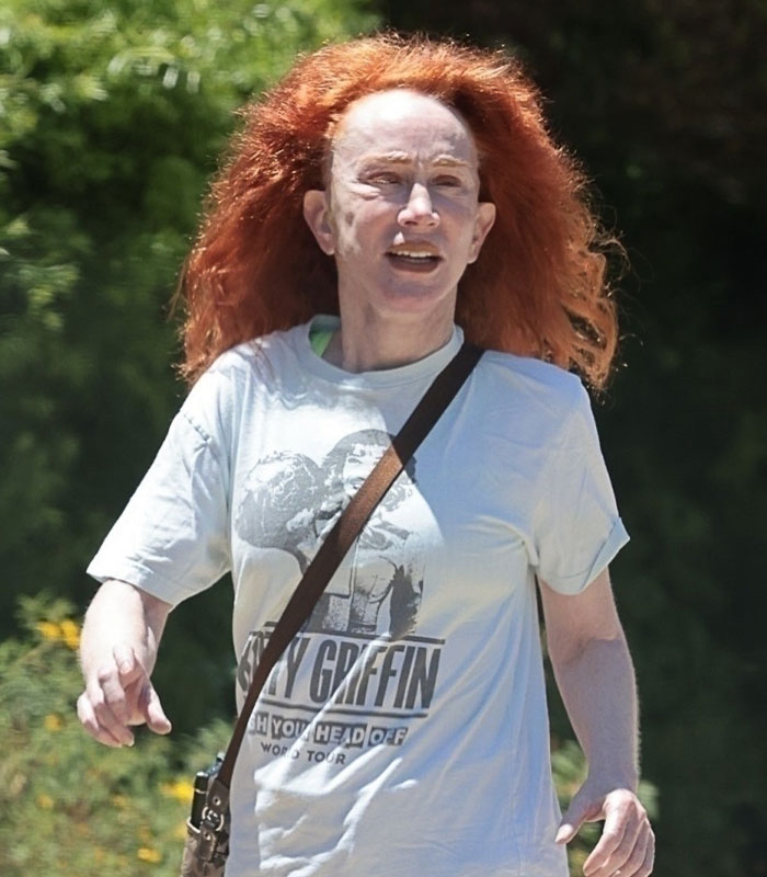Star in her 60s with fiery red hair, wearing a casual light t-shirt and crossbody bag, walking outdoors, revealing her relationship. Star in her 60s with fiery red hair, wearing a casual light t-shirt and crossbody bag, walking outdoors, revealing her relationship.