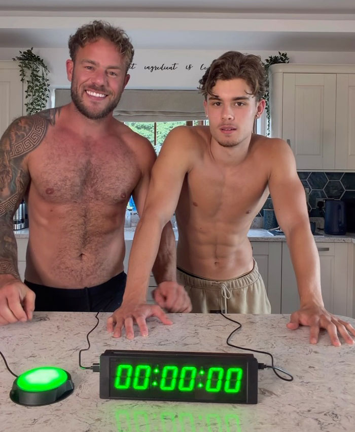 Controversial father-son adult content creators in a kitchen, smiling and ready to film new videos. Controversial father-son adult content creators in a kitchen, smiling and ready to film new videos.