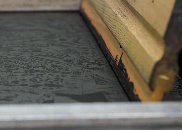 Screen printing with a squeegee, illustrating how reality can break for a second.