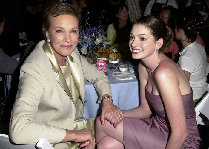 Julie Andrews and Anne Hathaway holding hands, a historic image related to the Disney backlash. Julie Andrews and Anne Hathaway holding hands, a historic image related to the Disney backlash.