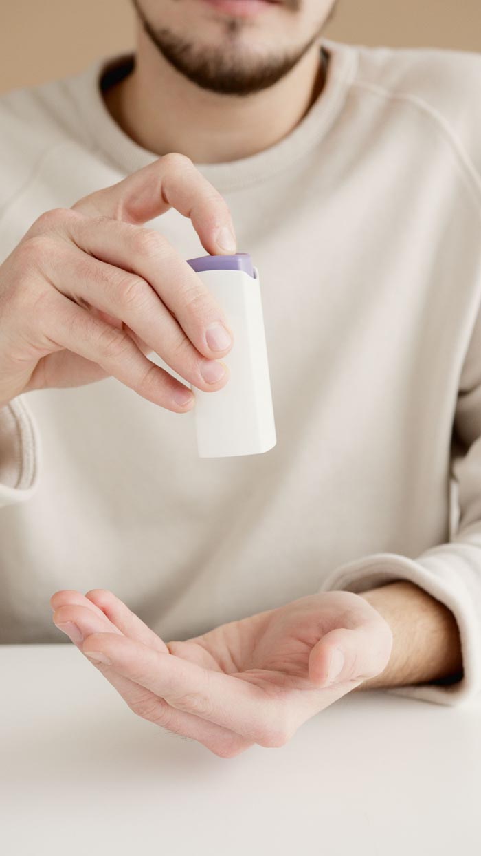 A man demonstrating unhygienic practices by putting something in his hand.