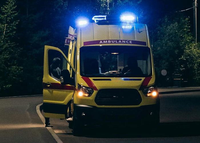 An ambulance at night, with flashing lights, revealing why people no longer look forward to their birthdays.