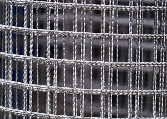 A close-up of a metal mesh fence, resembling a barrier, for women who had to leave immediately.