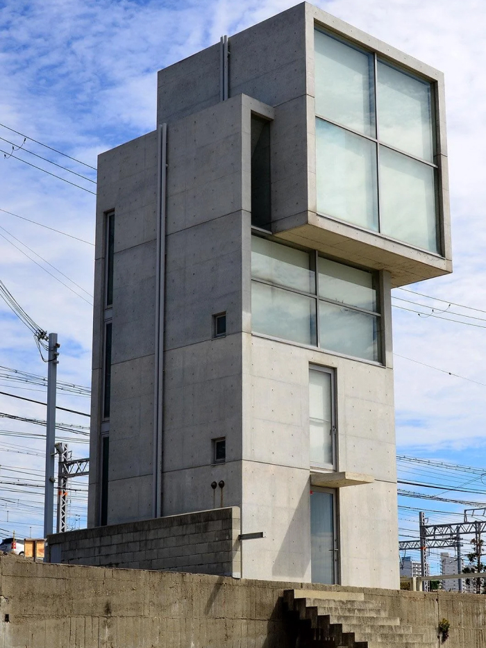Modern architecture design: A tall concrete building with large glass windows, showcasing an imposing modern architectural design.