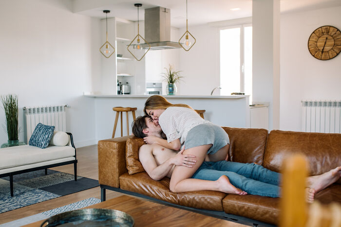 A couple embracing on a couch, an intimate moment that might be part of pocket dial stories.