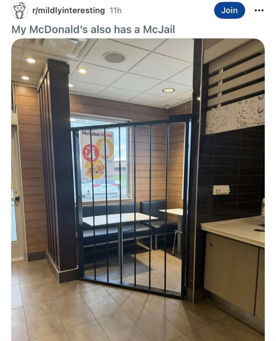 A hilariously unhinged screenshot of a McDonald's restaurant with a seating area enclosed by what looks like jail bars, called a McJail.